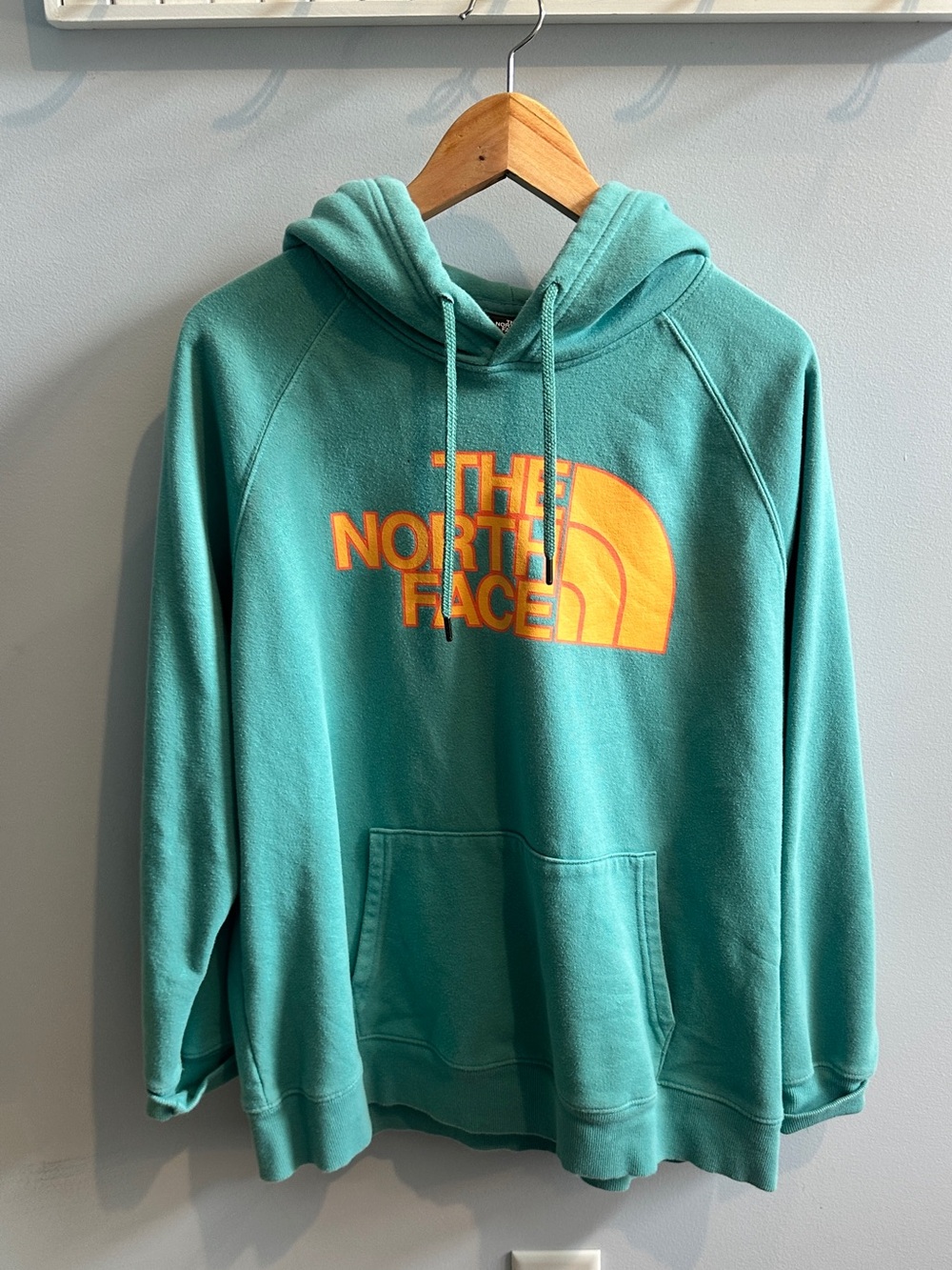 The North Face Teal Hoodie with Orange Logo